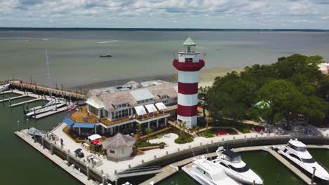 a wide orbiting shot of the lighthouse at harbor town on hilton head island, sc