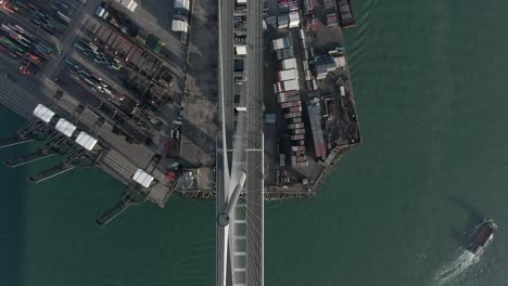 hong kong container terminal and port at victoria bay with full view of stonecutters bridge, storage terminal and docked ships, aerial footage