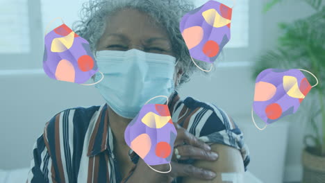 animation of face mask icons over african american woman with face mask