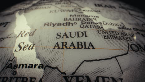 close-up of a world globe highlighting saudi arabia and surrounding countries