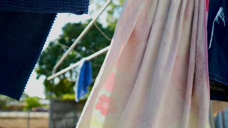 wet clothes hanging on clothesline on backyard