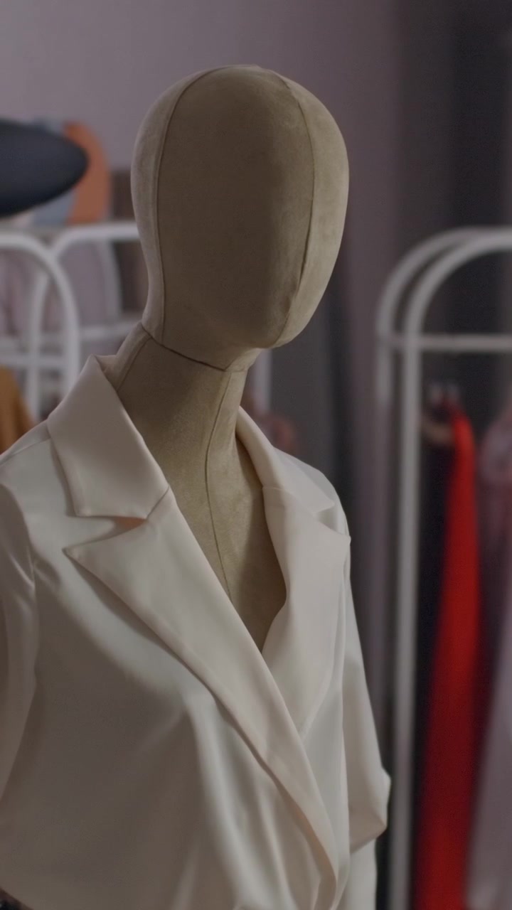Tailor Mannequin Wearing a White Blazer in a Fashion Studio