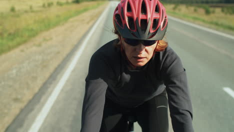 female cyclist riding bike on road