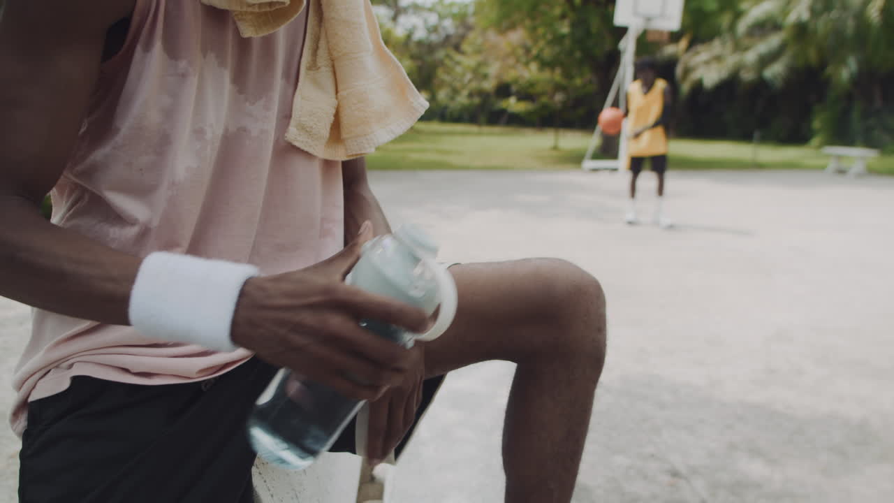 Black Basketballer Having Drink after Outdoor Training