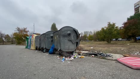 overfilled garbage bin and plastic rubbish bags causing environmental problem, static shot, couch, sofa, armchair at background