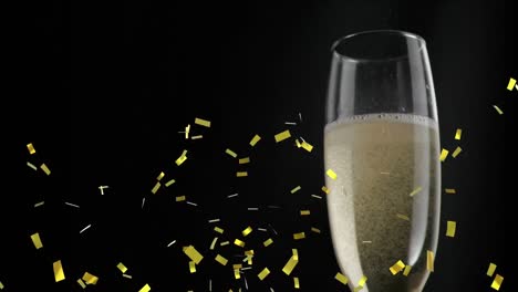 Animation-of-champagne-glass-and-confetti-falling-on-black-background