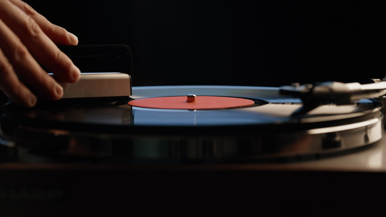 Man hand cleaning record playing on vintage turntable closeup. Macro vinyl disc