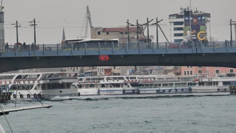 galata bridge in istanbul with boats and cityscapes