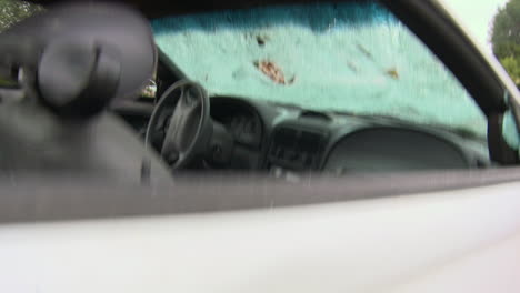 a man destroys his car with a sledgehammer