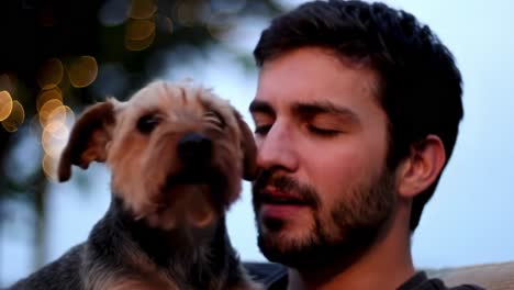 a heartwarming moment between a person and their beloved dog, captured in soft lighting, showcasing their close bond and affection in a relaxed atmosphere