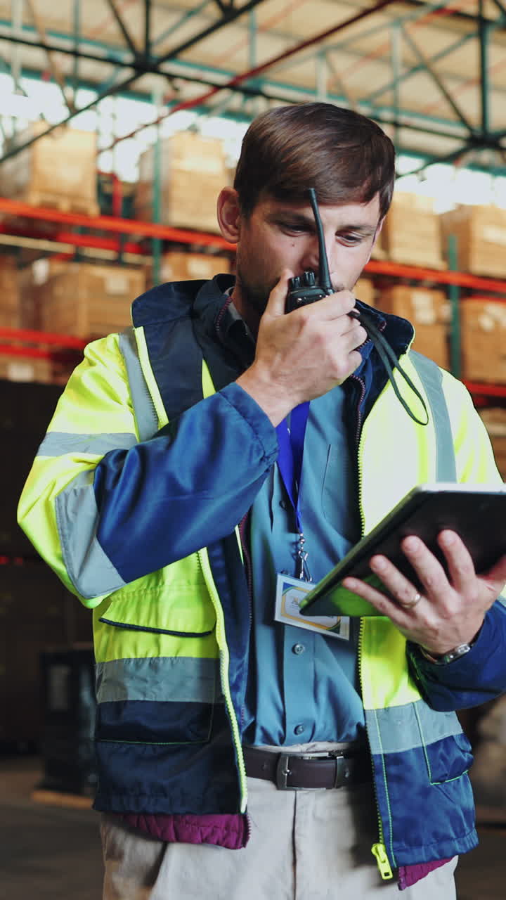 Warehouse worker using walkie-talkie and tablet