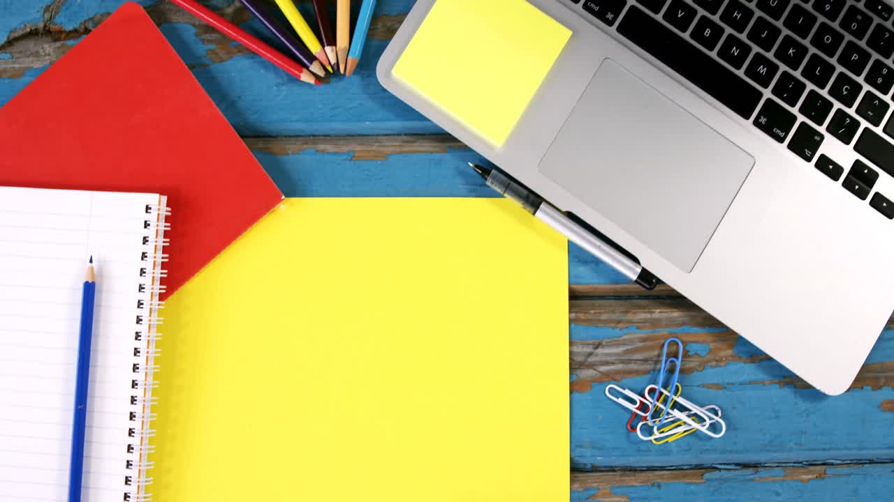 Diary, pencils, paper clips and laptop