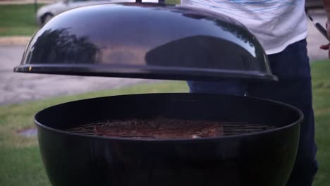 man covering grill - steak bbq