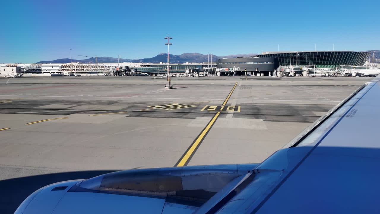 Nice, France - March 20, 2025: View from an airplane window of an airplane moving through the airport before departure