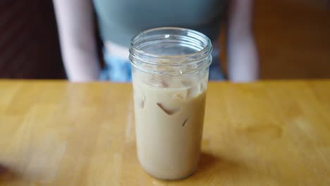 iced coffee in a glass mason jar cup