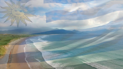 composición digital de la bandera uruguaya ondeando contra la vista aérea de la playa y las olas del mar