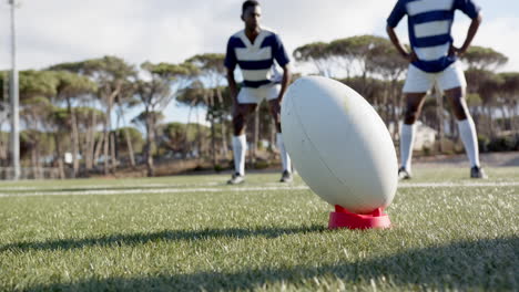 rugby, african american male athletes preparing for kickoff on field, focusing on ball, copy space