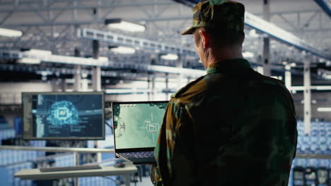 military technician in data center tracking satellite coordinates using notebook