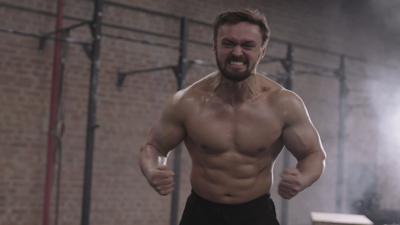 Portrait of Muscular Sportsman in Gym