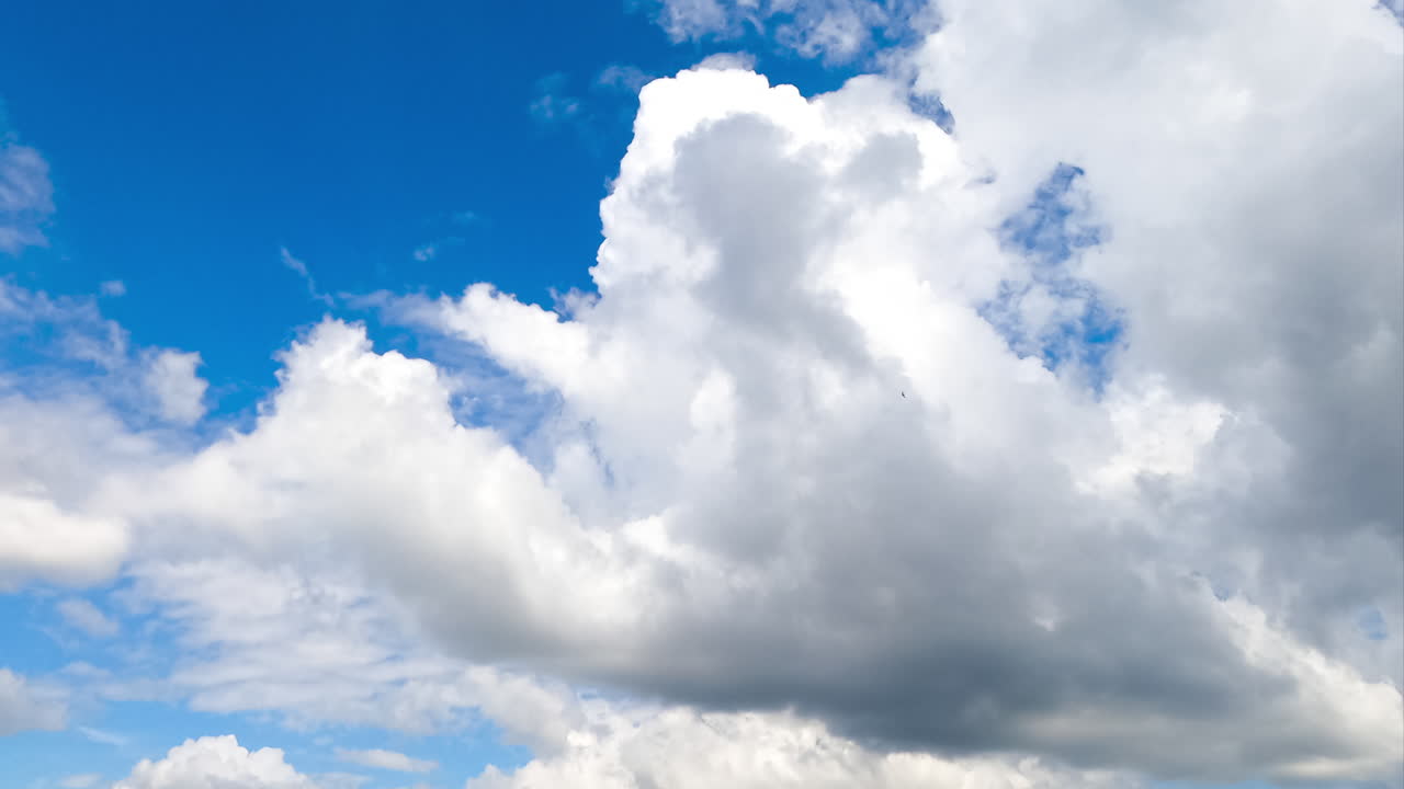 Flying along fluffy soft cotton clouds on beautiful sunny summer day. Heavenly cumulus white clouds movement timelapse.