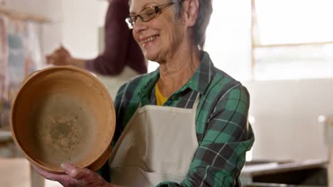 Female-potter-examining-a-earthenware-pot