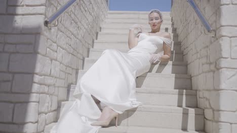 elegant bride posing on stairs