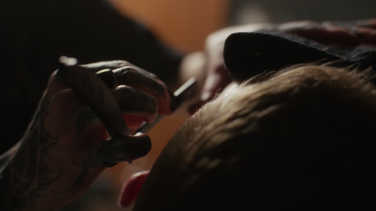 Tattooed Barber Giving a Haircut