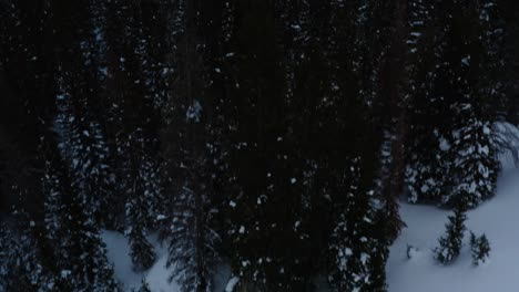 aerial forward pan up shot of snowy mountains overlooking the horizon