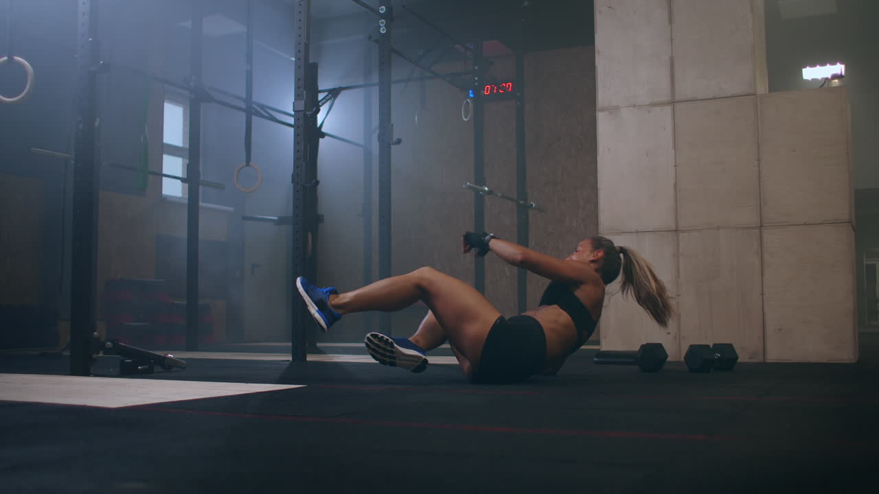 después de un duro entrenamiento la atleta cayó al suelo pero todavía se levanta superando el dolor y las dificultades y la fatiga