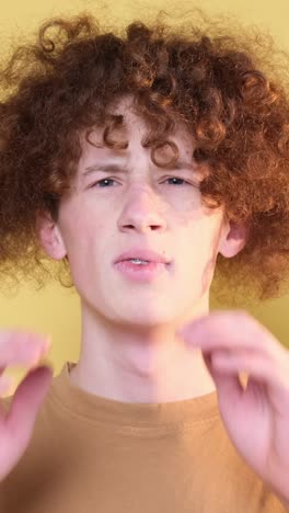 negative emotions on the camera of a young man a student with curly hair the emotion of disgust negative emotions on the camera of a young man a student with curly hair the emotion of disgust revulsion