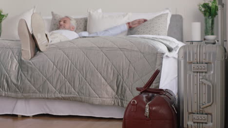 tourist man jumping on hotel bed resting after successful travel journey enjoying retirement vacation