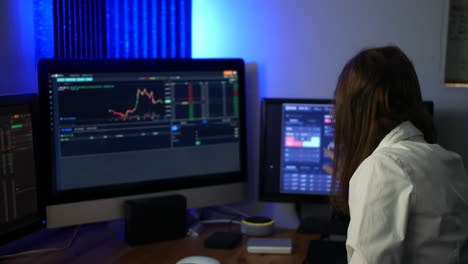 Female-stock-market-trader-analyst-analysing-data-on-computer-screens