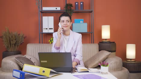 Home-office-worker-young-woman-gets-frustrated-while-looking-at-phone.