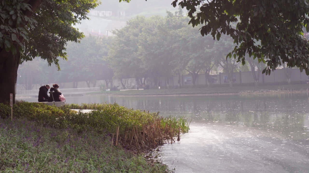 The retired couple are playing in the park with their grandchildren