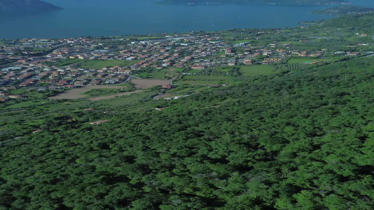 A stunning aerial view from Balota del Coren, capturing the calm waters of Lake Iseo and the majestic Monte Isola. This peaceful drone shot showcases the natural beauty of northern Italy.