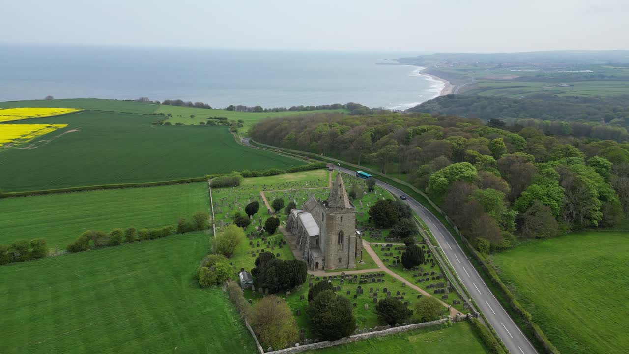 Aerial drone footage of St Oswald’s Church, Lythe, North Yorkshire, showcasing its historic architecture, coastal views, and scenic village surroundings