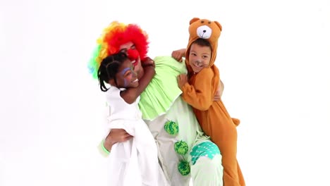 Animation-of-red-shapes-moving-over-diverse-happy-children-and-clown-hugging-at-party,-on-white