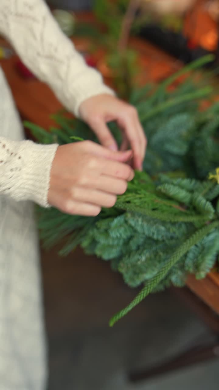 mujer haciendo una corona de Navidad