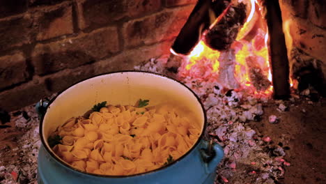 Adding-noodles-to-cast-iron-pot---traditional-South-African-cooking-on-open-fire