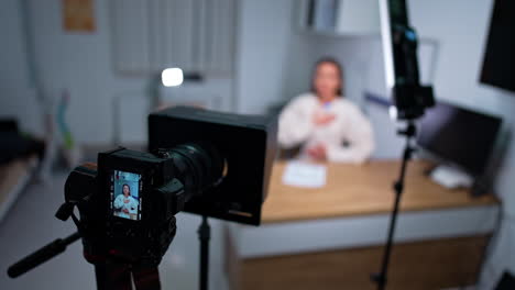woman holding one hand on the chest and another one on the stomach talks to camera. female blogger filming content for health blog.
