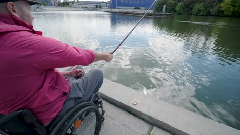 person with a physical disability who uses wheelchair fishing from fishing pier