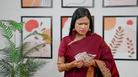 Sad-Indian-woman-counting-money