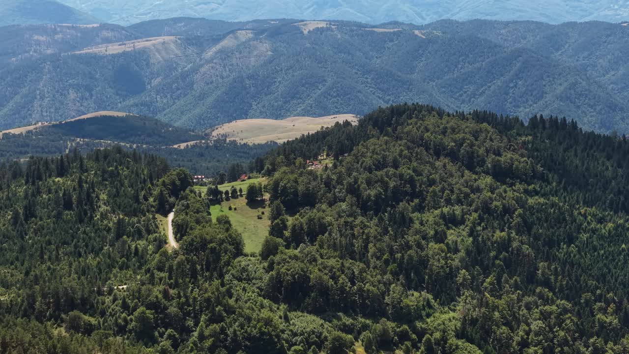 Aerial View of Idyllic Mountain Landscape Scenery in Summer Season, Pine Forest and Hilltop Homes