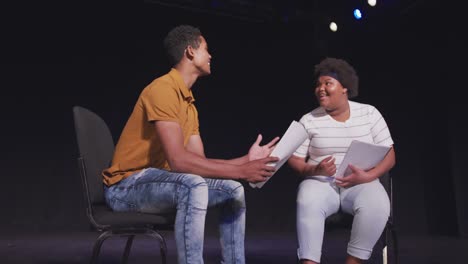 students preparing before a high school performance in an empty school theater