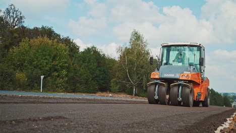 heavy asphalt roller that stack and press hot asphalt. road repair machine. repairing in modern city with vibration roller compactor