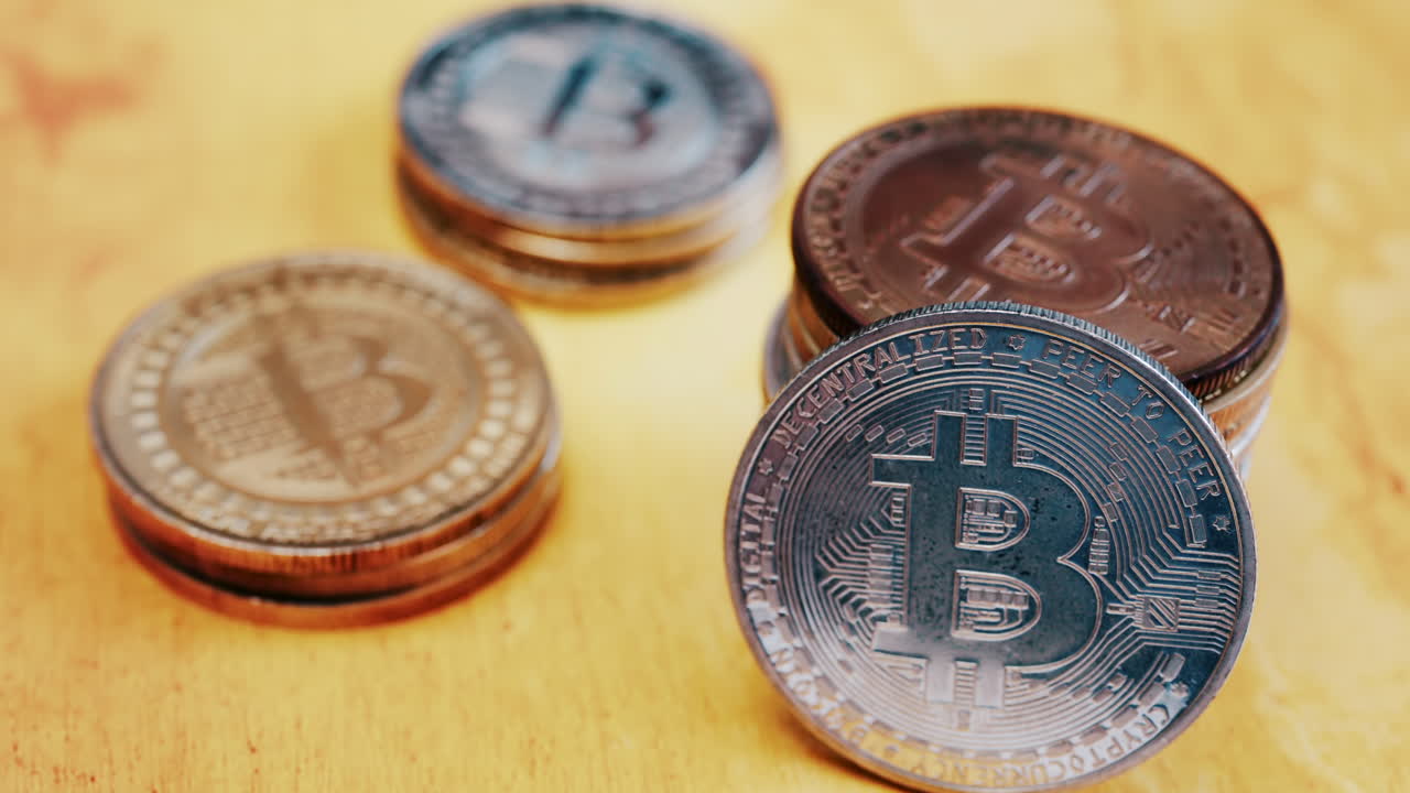 Close up of shiny physical Bitcoin coins stacked on a table