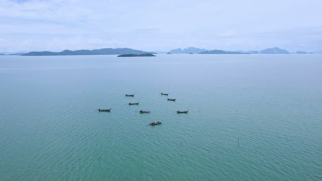 long tail boats in the waters of phang nga bay with scenic aerial views across the sea