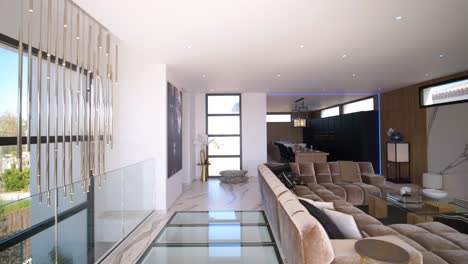 slow establishing shot of a large couch and cinema area within a villa