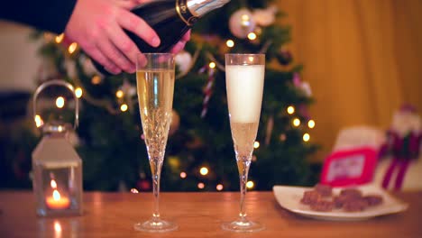 A-man-pours-a-second-glass-of-champagne-at-Christmas