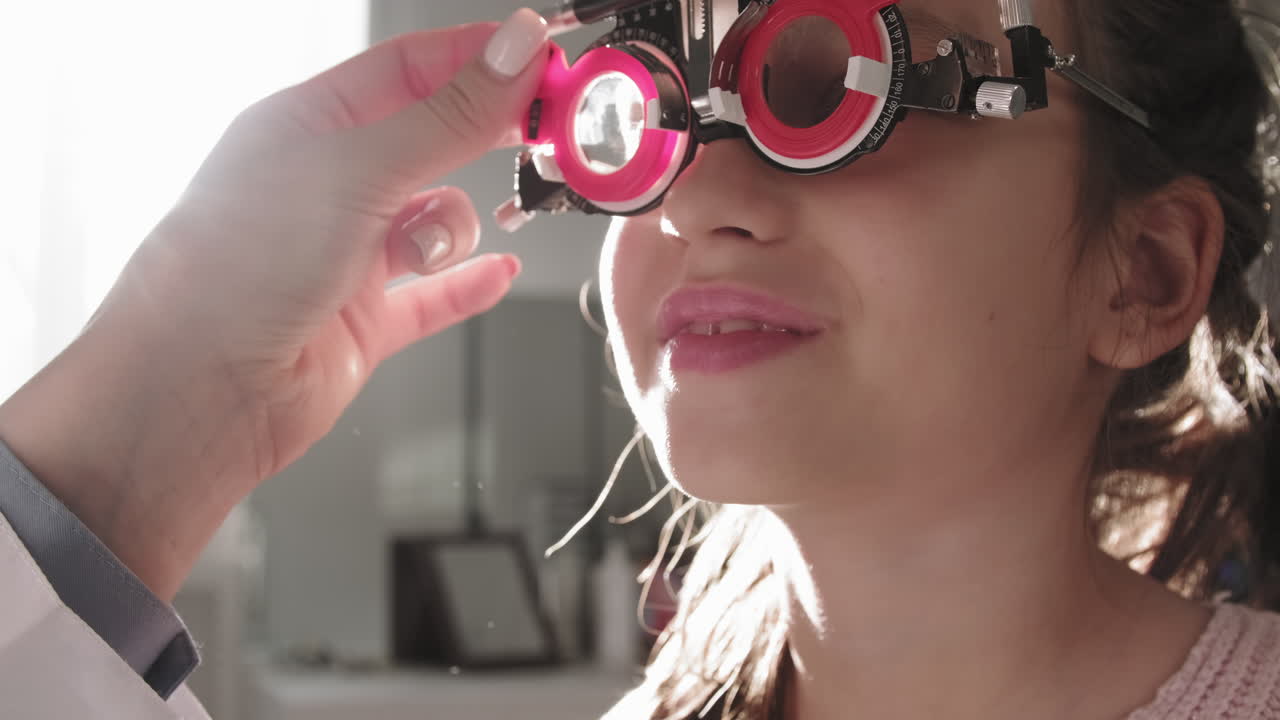 Optometrist Checking Girl Vision With Trial Frame